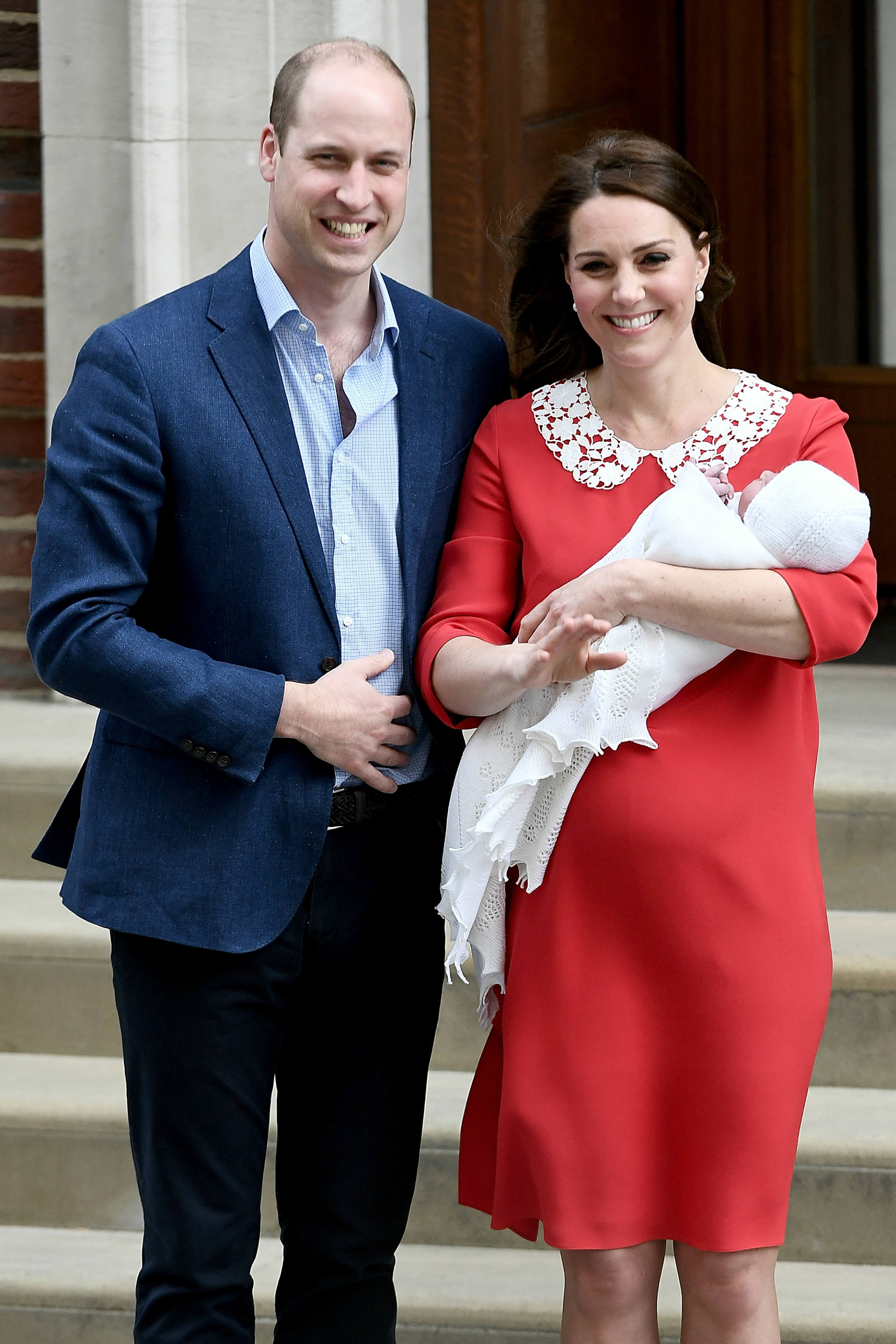 Prince William and Kate Middleton smile with the royal baby