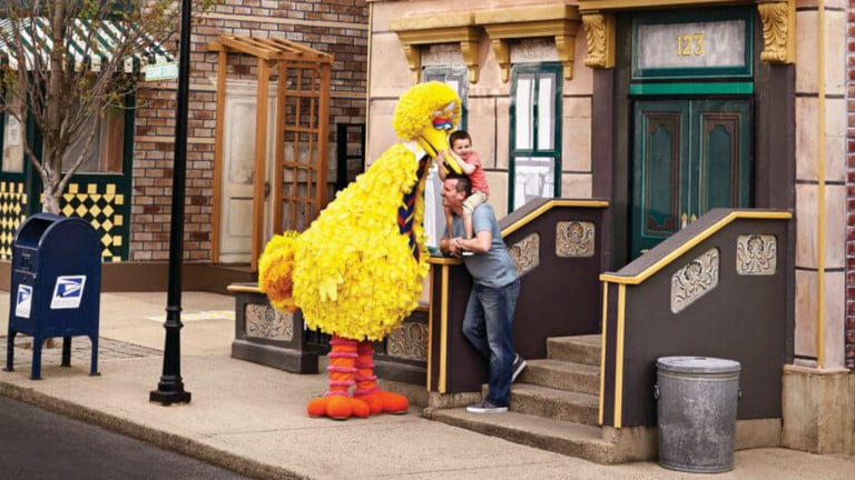 Father and child with Sesame Street character