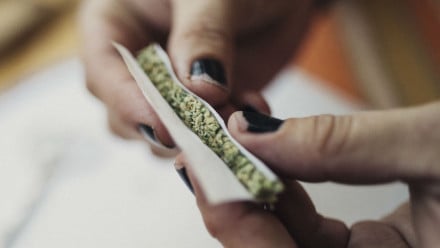 Woman rolling a joint with weed in it
