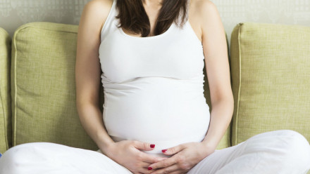 Pregnant woman sitting on couch