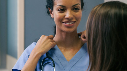 A doctor about to talk to a woman
