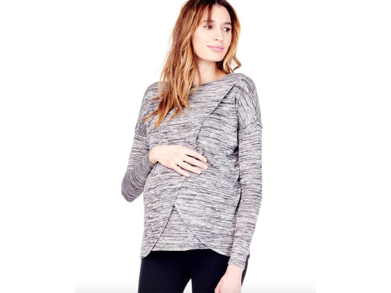 A pregnant woman wearing a workout maternity sweater