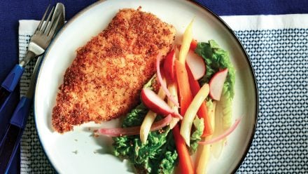 breaded chicken cutlet with pickled veg on a bed of lettuce
