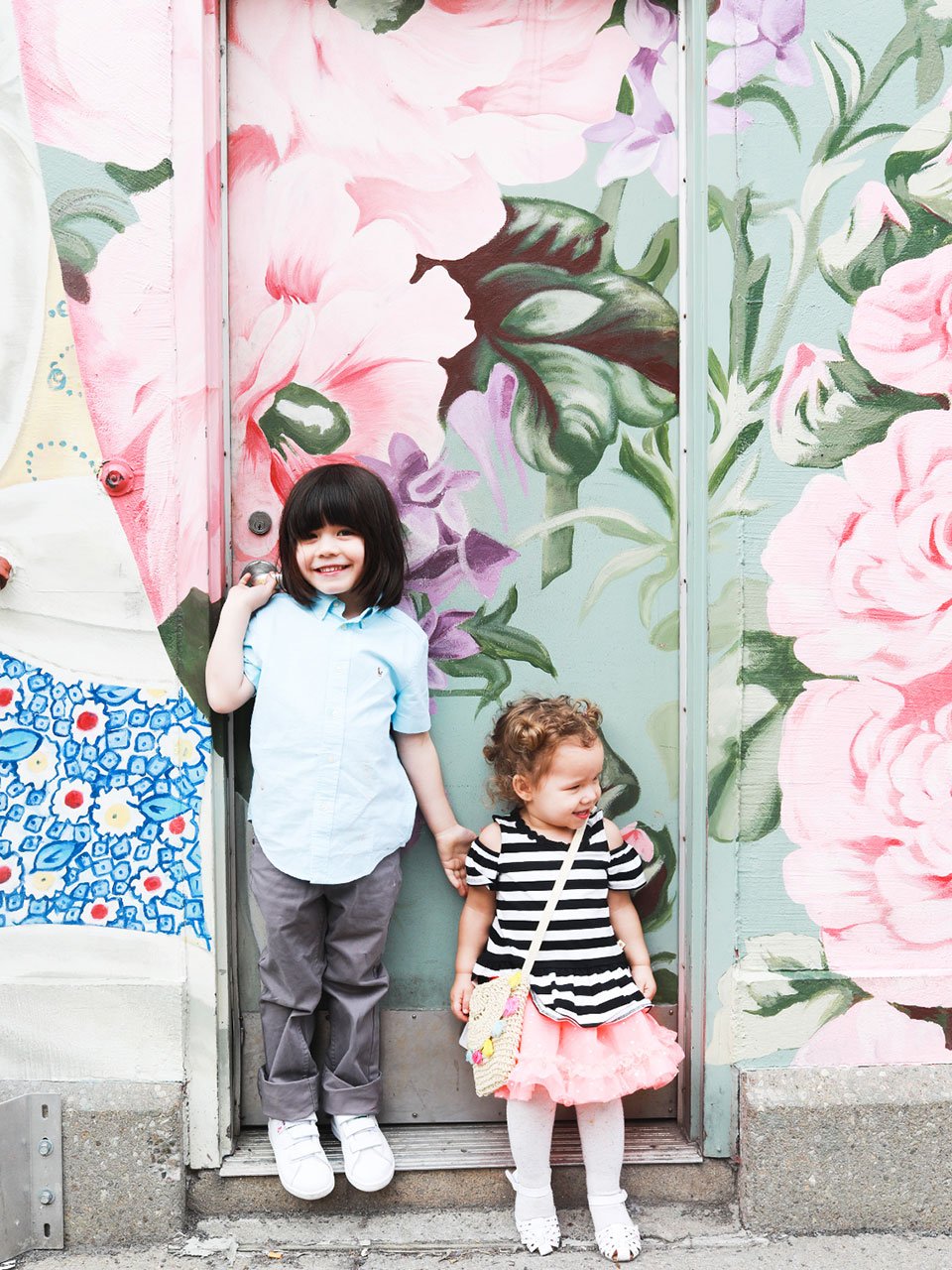 Author's kids standing in front of a mural wearing marshalls clothing