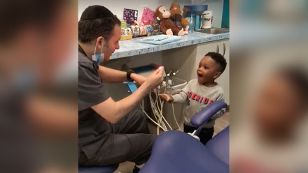 Screenshot from video of dentist doing magic tricks for his patients