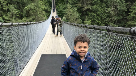A little boy standing on Capitano Suspension Bridge in Vancouver