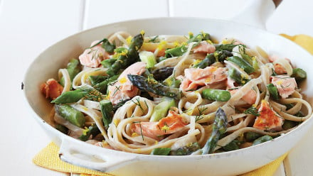 Skilled with creamy pasta topped with flakes of salmon and spears of asparagus