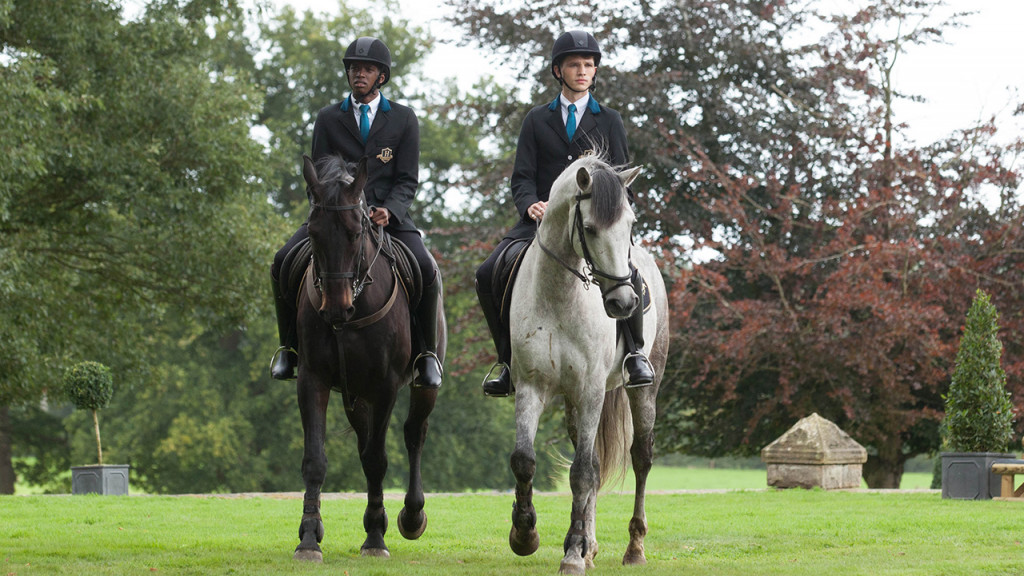 Promo image for Free Rein showing two boys on horseback