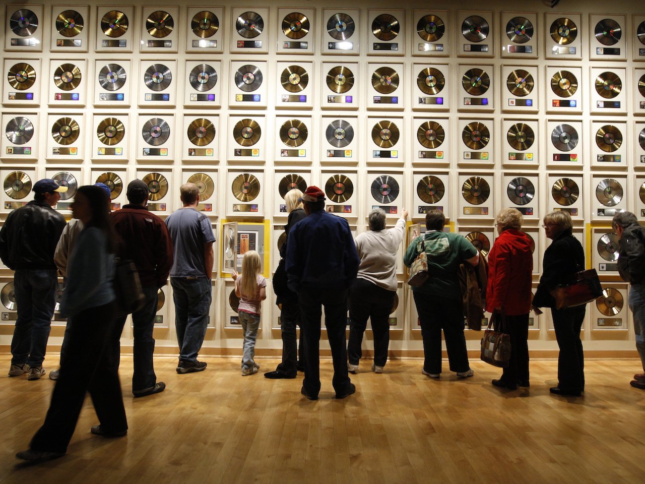 People looking at records on the wall