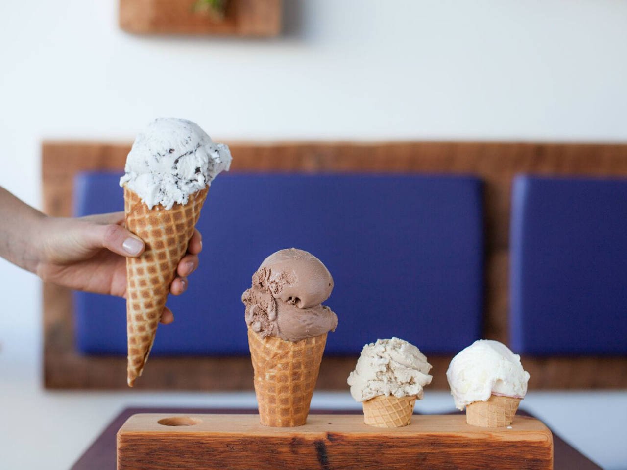 Four scoops of ice ream in waffle cones from Rain or Shine Ice Cream 