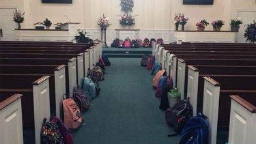 Chapel with backpacks lining the aisles