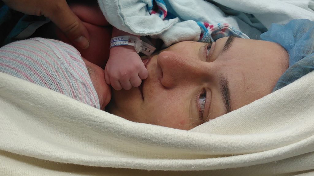 Woman in the hospital holding a newborn