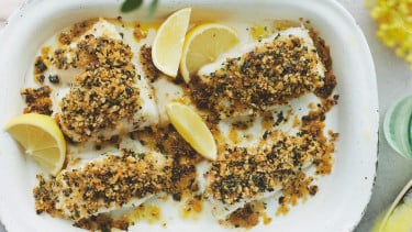 dish with breaded fish and lemons