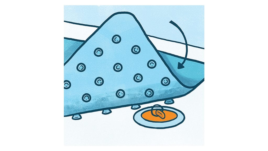 Illustration showing a bath mat being laid over a tub drain