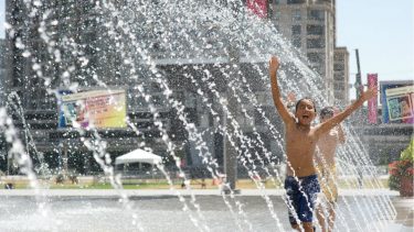 Two kids having fun in Celebration Square Mississauga's Splash pad