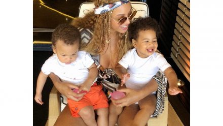 Beyoncé holding her twins Rumi and Sir Carter in her lap