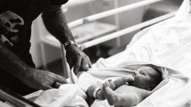 Dad taking care of newborn baby in a hospital