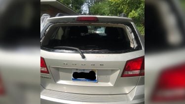 Picture of a minivan with the back window smashed