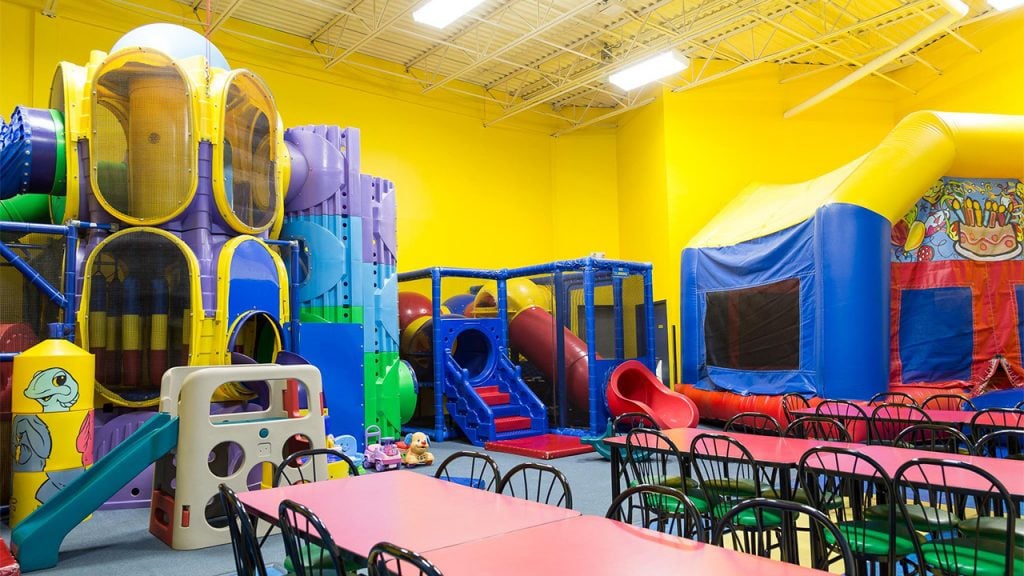 Play room with large play structure and party tables