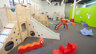 Wooden play structures in a large play room