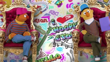 Ernie and Bert from Sesame Street sitting on thrones in front of a graffiti wall