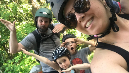 A family posing in helmets while on a bike ride