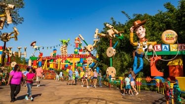 Guests walking around the entrance of Toy Story Land