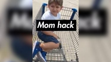kid sitting inside a grocery cart