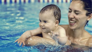 Mom and baby swimming in a pool
