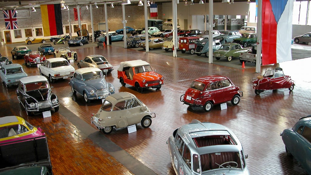 Many vintage cars on the wooden floor