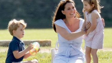 Kate Middleton tickling Princess Charlotte while Prince George plays with a slinky
