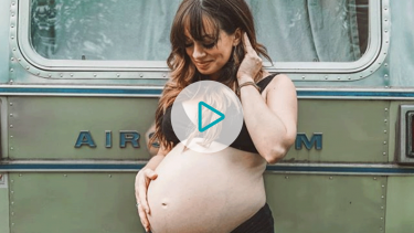 Kristen Sarah in pregnant in front of her Airstream bus