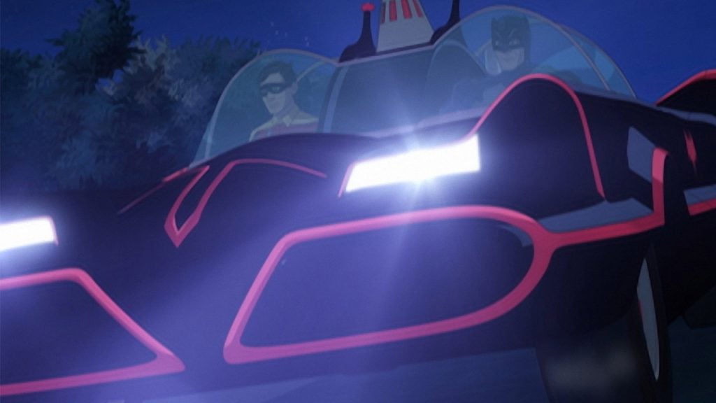 Promo image for Batman return of the caped crusader showing batman and robin riding in the batmobile at night