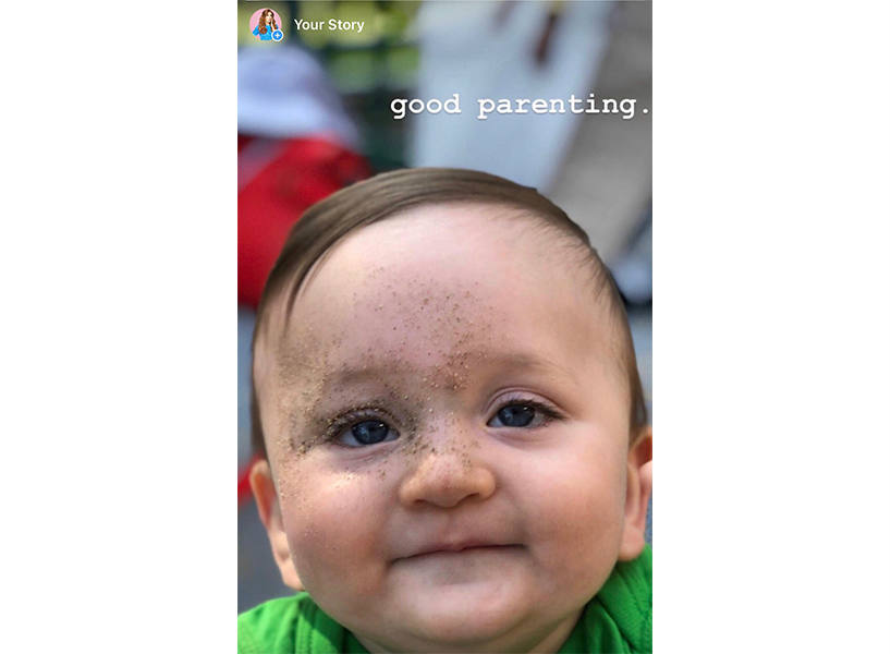 A baby with sand on his face