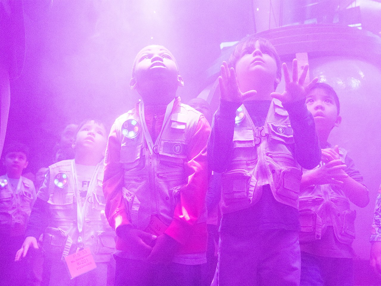 kids exploring under purple lights