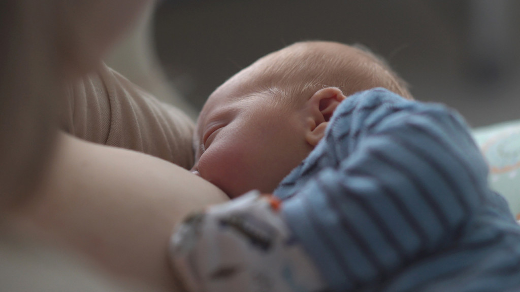baby breast feeding while sleeping