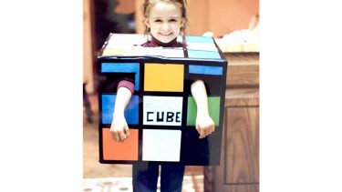 young girl dressed up as a Rubik's Cube