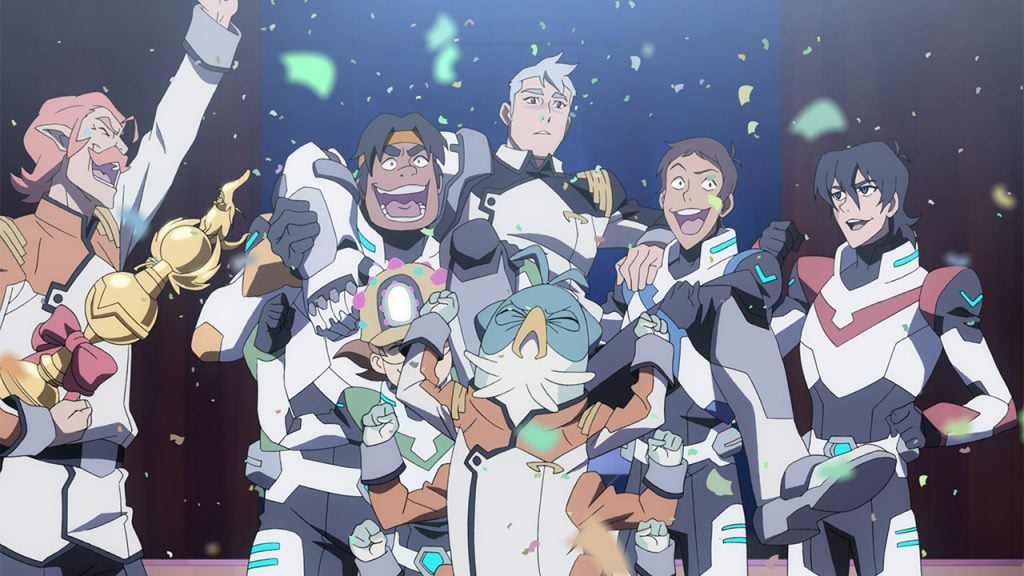 Promo image for Voltron Legendary Defender showing a group of astronauts celebrating with confetti and a big trophy