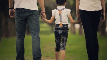 Image of family walking hand in hand