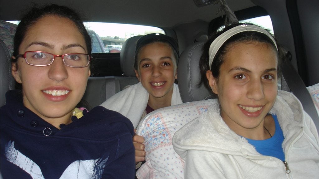 three sisters sitting in a car