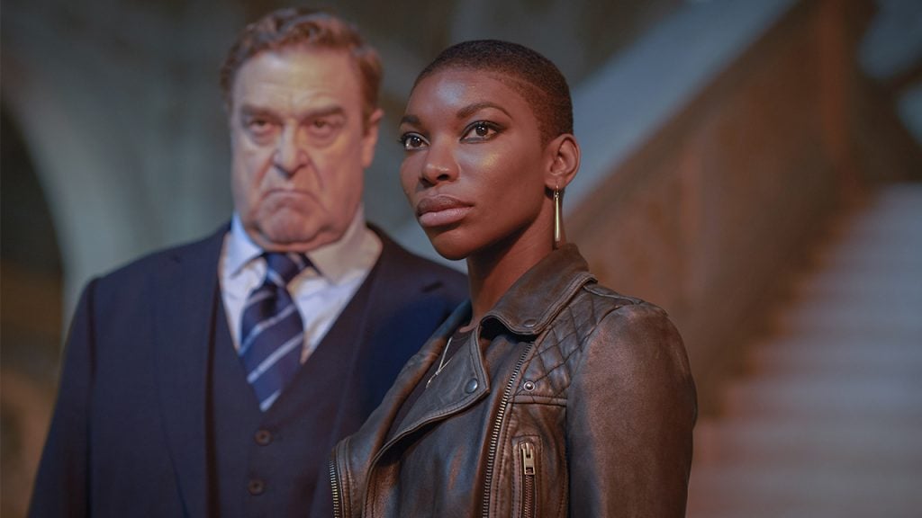 Promo image for Black Earth Rising showing a man and woman standing at the base of a staircase looking angry