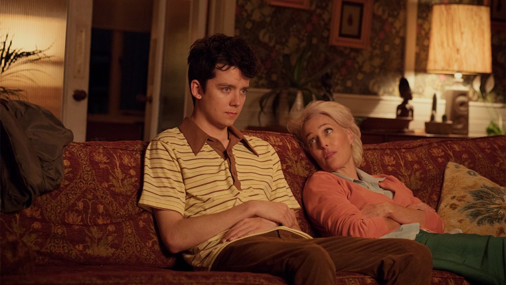 Promo image for Sex Education showing a young man and a woman sitting on a couch