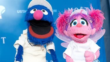 Grover and Abby Cadabby from Sesame Street posing at an event