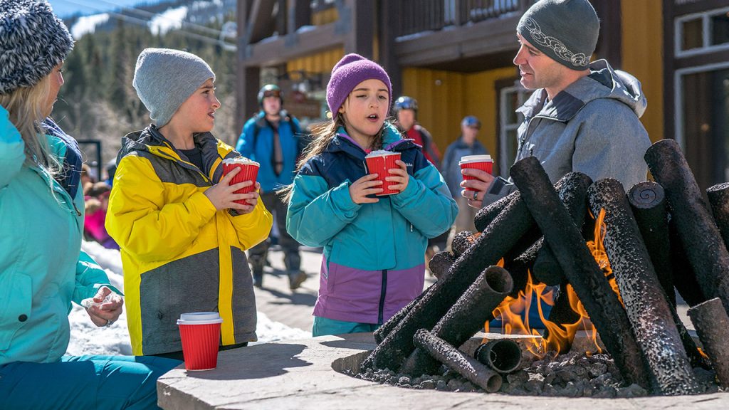 kids around a fire drinking hot chocolate