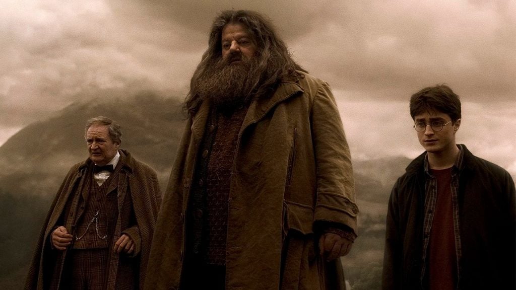 Promo image for Harry Potter and the Half-Blood Prince showing three men standing in a field looking sad