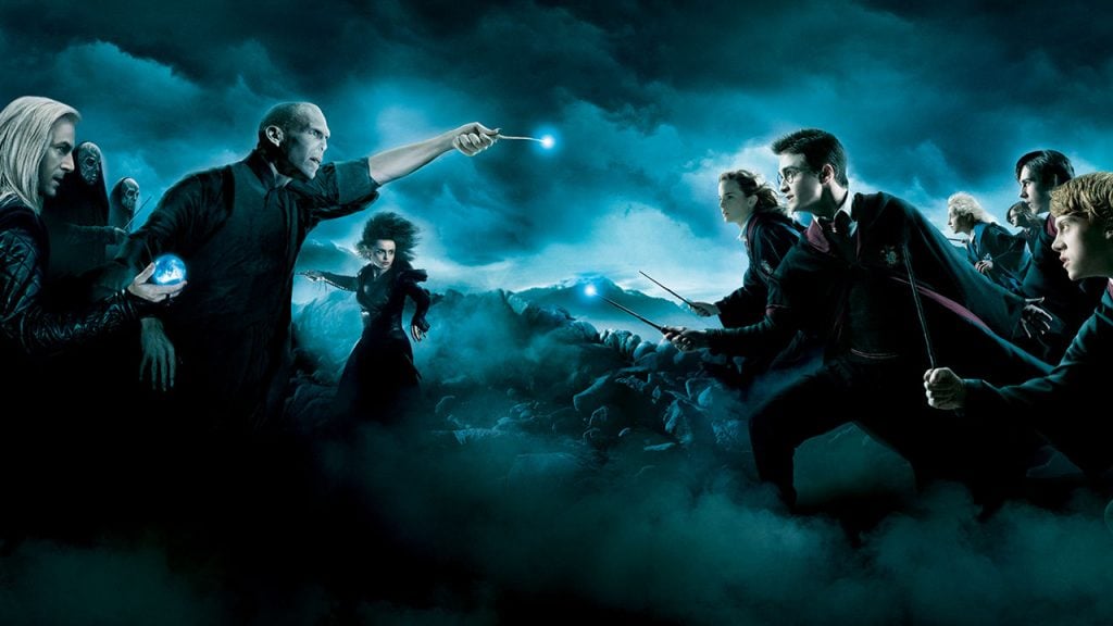 Promo image for Harry Potter and the Order of the Phoenix showing a battle between the good and bad wizards and witches