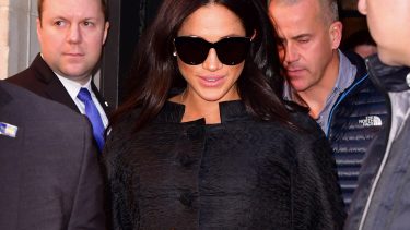 meghan markle in dark sunglasses and a black coat in new yeork