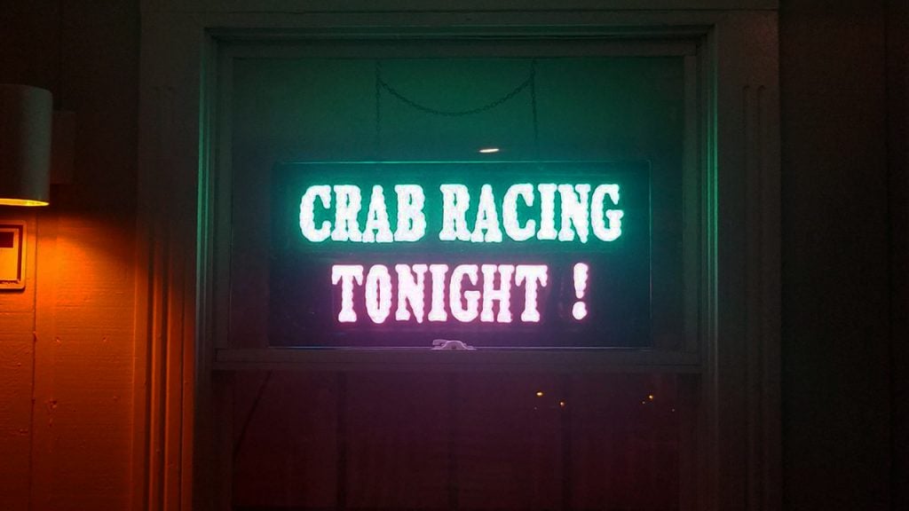 Photo of a neon sign that says Crab Racing Tonight!