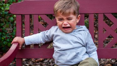 kids crying on a park bench