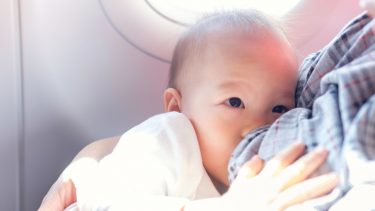 Baby nursing on an airplane.